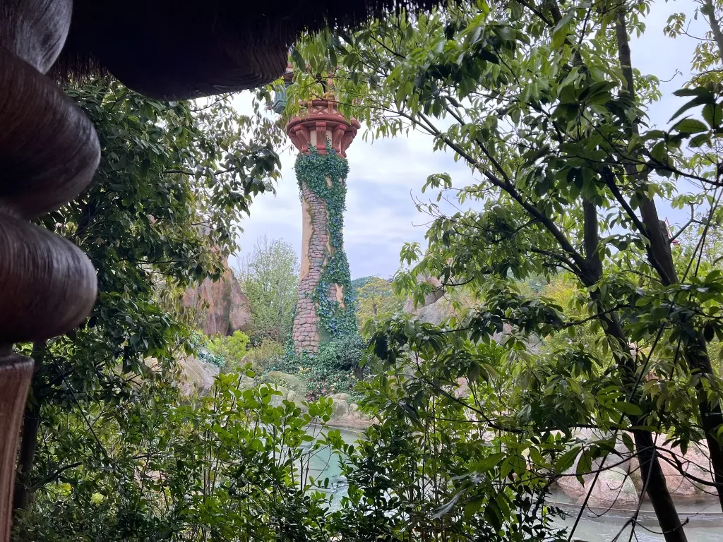 Rapunzel's tower seen through quiet foliage at Tokyo DisneySea, with no crowds visible